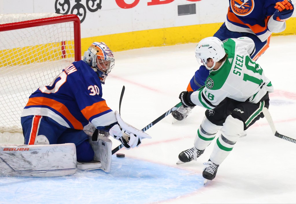 
Ilya Sorokin #30 of the New York Islanders makes a save against Sam Steel #18 of the Dallas Stars