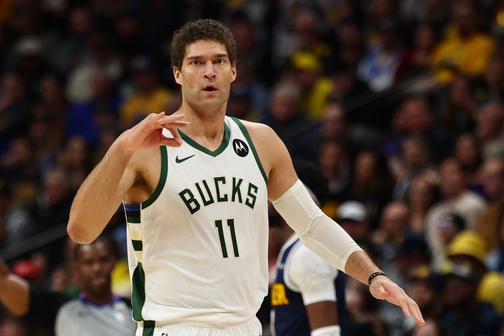 Brook Lopez #11 of the Milwaukee Bucks celebrates after making a three point basket against the Denver Nuggets.