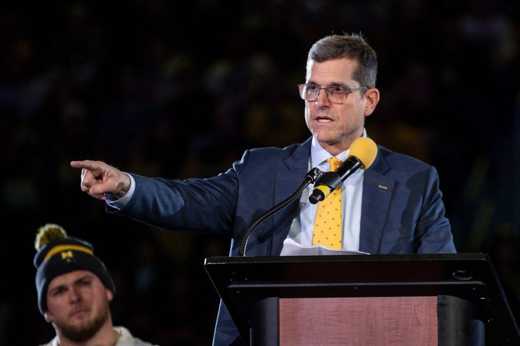 Michigan head coach Jim Harbaugh speaks during the national championship celebration at Crisler Center in Ann Arbor.