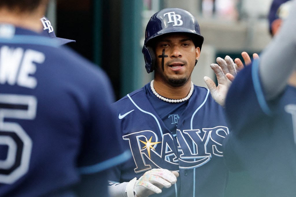 Tampa Bay Rays shortstop Wander Franco (5) receives congratulations from teammates after scoring in the sixth inning against the Detroit Tigers.