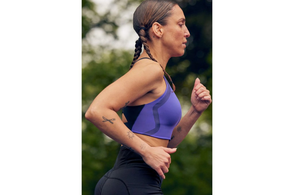 a woman running in a blue sports garment