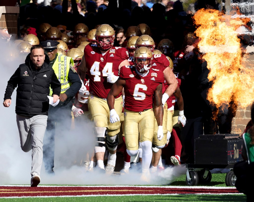 Boston College football team running onto field before a game against Virginia Tech, Jeff Hafley leading the way. (AP Photo/Mark Stockwell)