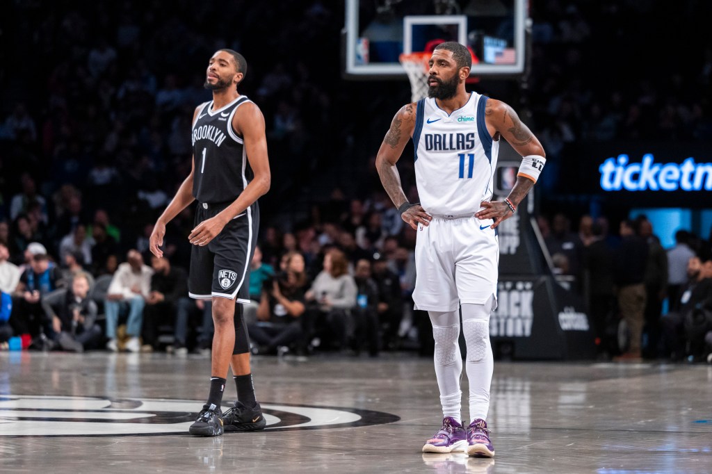 Kyrie Irving and Mikal Bridges playing basketball on court in Brooklyn Nets vs. Dallas Mavericks game at Barclays Center.