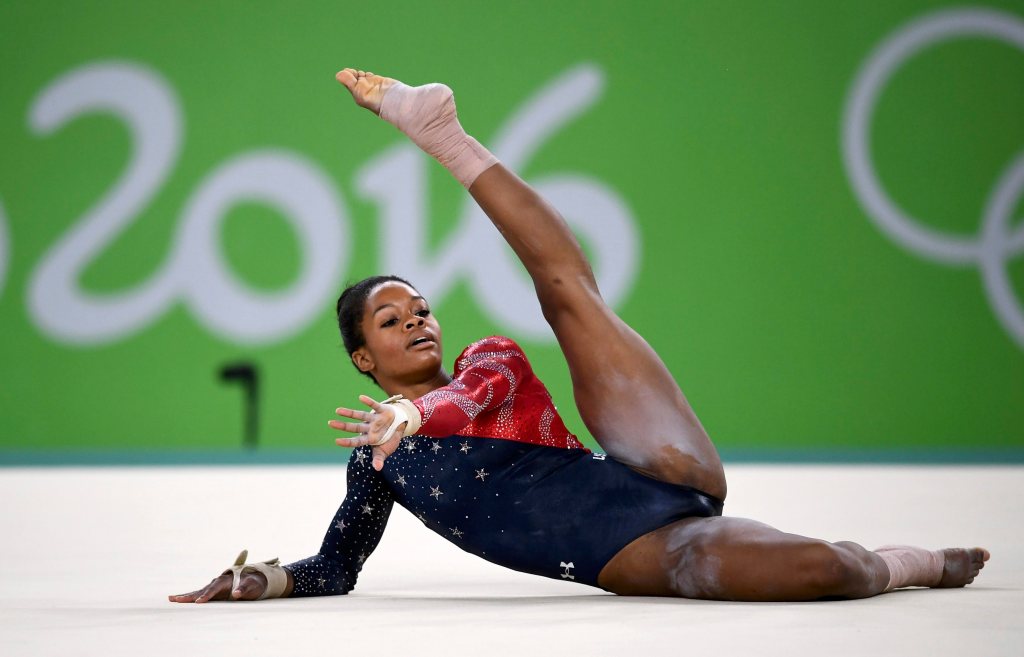 Gabby Douglas competing in women's gymnastics on the floor at the Rio Olympics 2016.