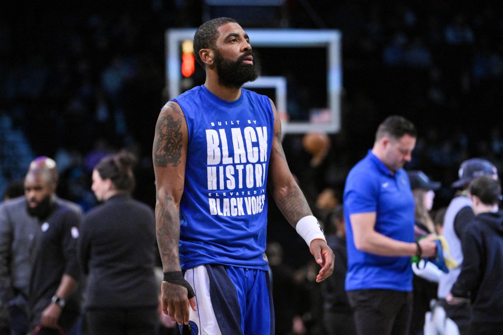 Kyrie Irving (#11) of the Dallas Mavericks warms up in a blue shirt before a game against the Brooklyn Nets at Barclays Center.