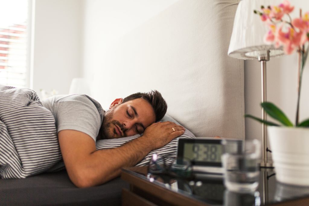 STOCK Handsome young man sleeping peacefully in his bedroom