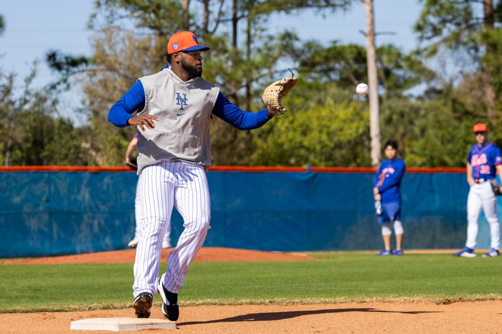 Luis Severino, a man in a baseball uniform, throwing a baseball during New York Mets Spring Training in Port St. Lucie, FL on Feb. 14, 2024.