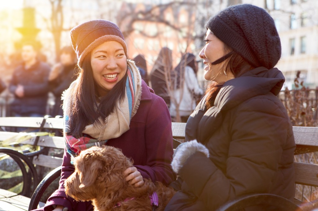 Woman sitting in park with dog