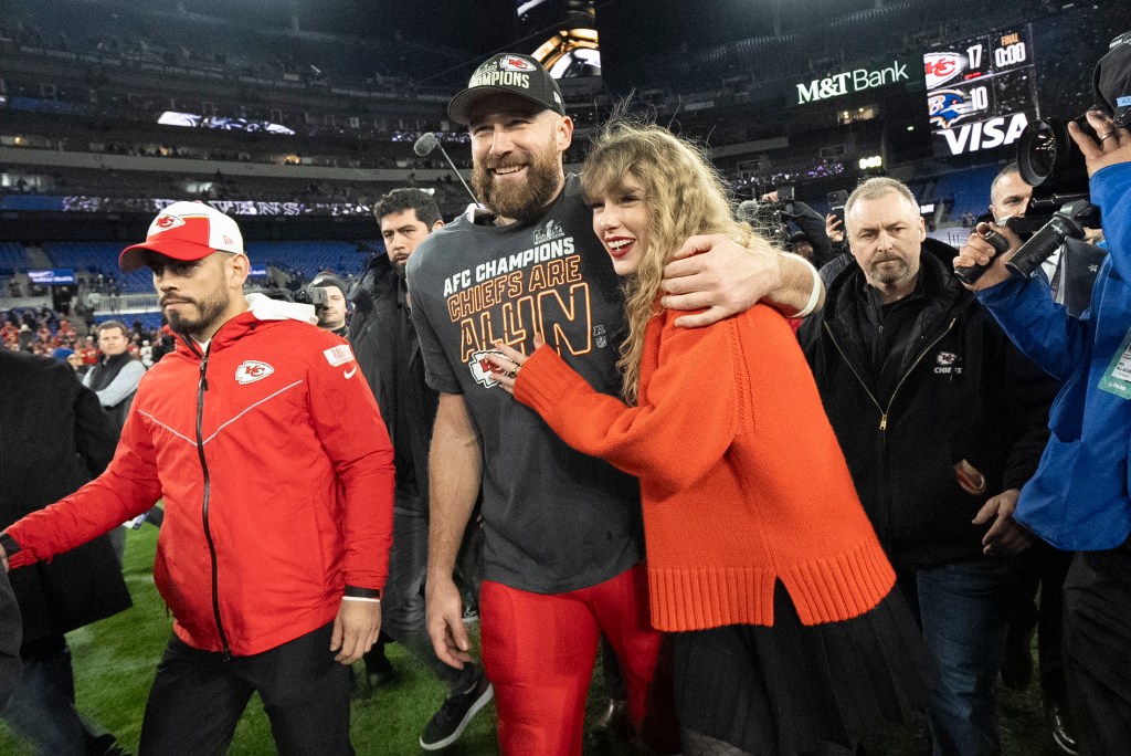 Chiefs tight end Travis Kelce and Taylor Swift walk together after the Chiefs won the AFC Championship NFL game against the Baltimore Ravens.