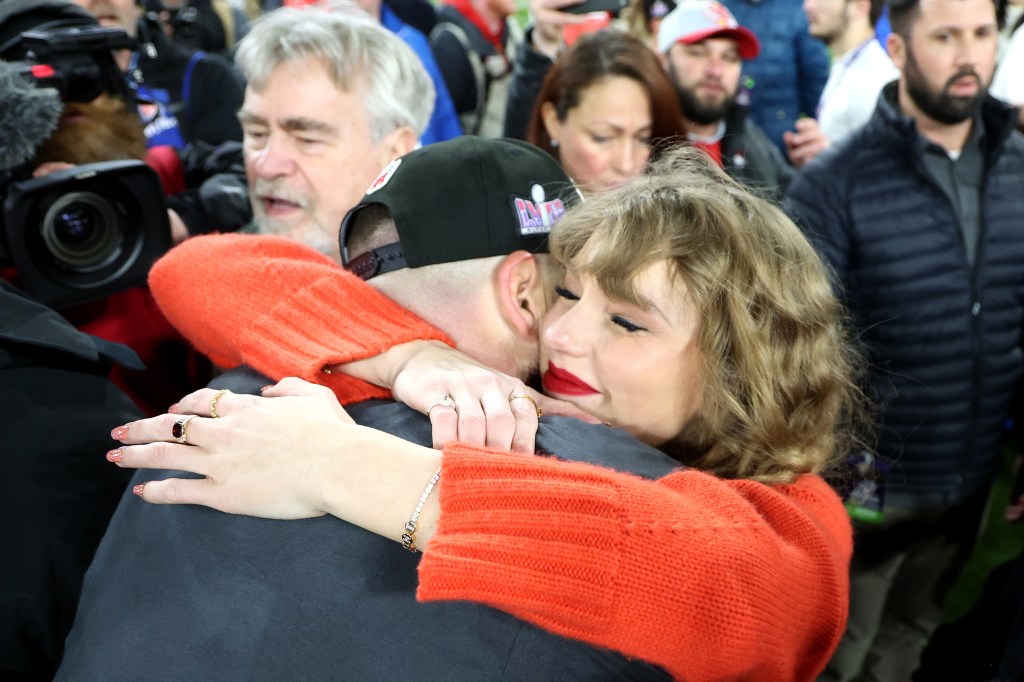 Travis Kelce #87 of the Kansas City Chiefs celebrates with Taylor Swift after a 17-10 victory against the Baltimore Ravens in the AFC Championship Game.