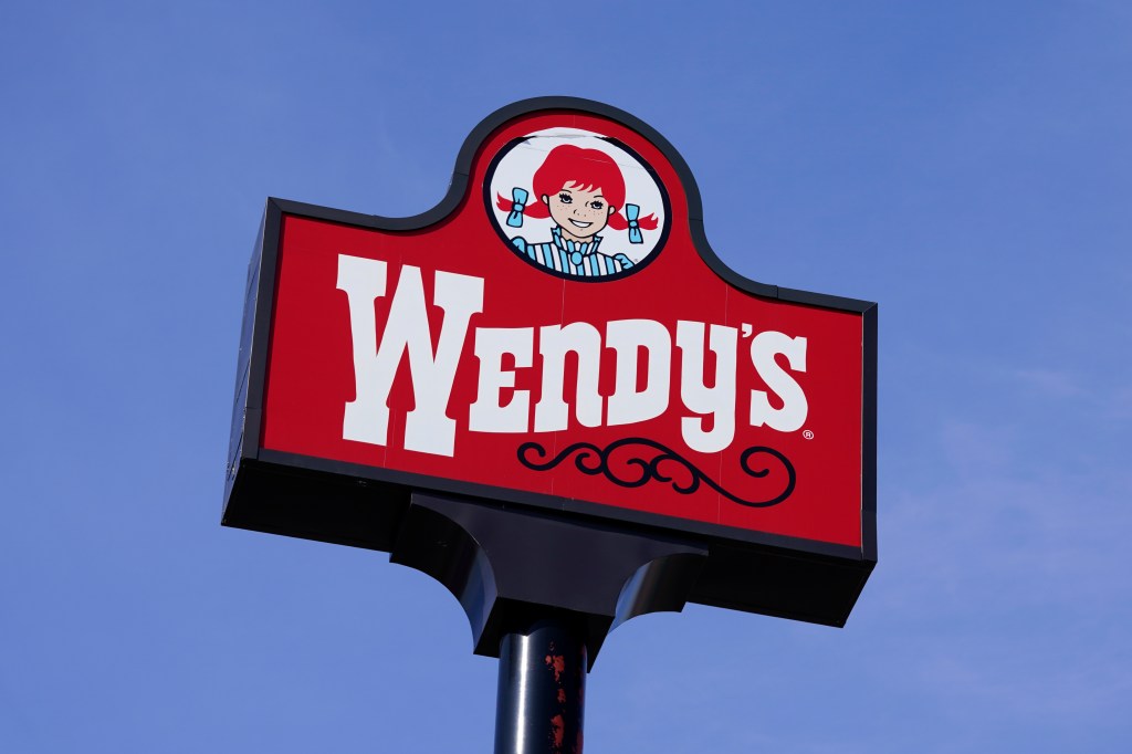 FILE - A sign stands over a Wendy's restaurant, Feb. 25, 2021, in Des Moines, Iowa.  Wendyâs says that it has no plans to increase prices during the busiest times at its restaurants, Wednesday, Feb. 28, 2024. The burger chain clarified its stance on how it will approach pricing after various media reports said that the company was looking to test having the prices of its menu items fluctuate throughout the day based on demand.  