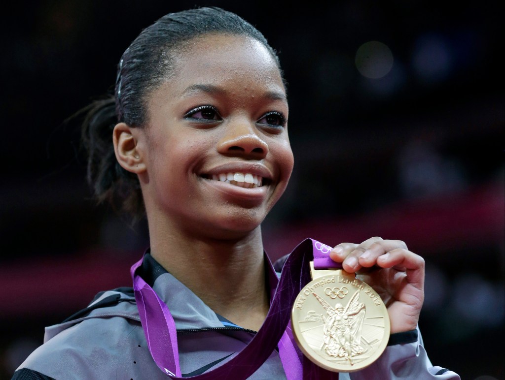 Gabby Douglas holding her gold medal during the artistic gymnastics women's individual all-around competition at the 2012 Summer Olympics in London.