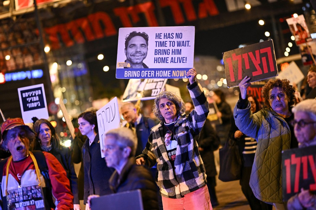 People in the streets holding signs. 