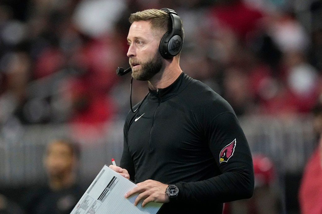 Kliff Kingsbury watching an NFL game, hired as Las Vegas Raiders offensive coordinator.