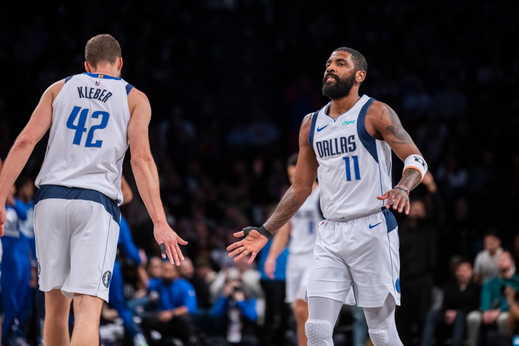 Dallas Mavericks guard Kyrie Irving (11) celebrates with forward Maxi Kleber (42) during a basketball game at Barclays Center.