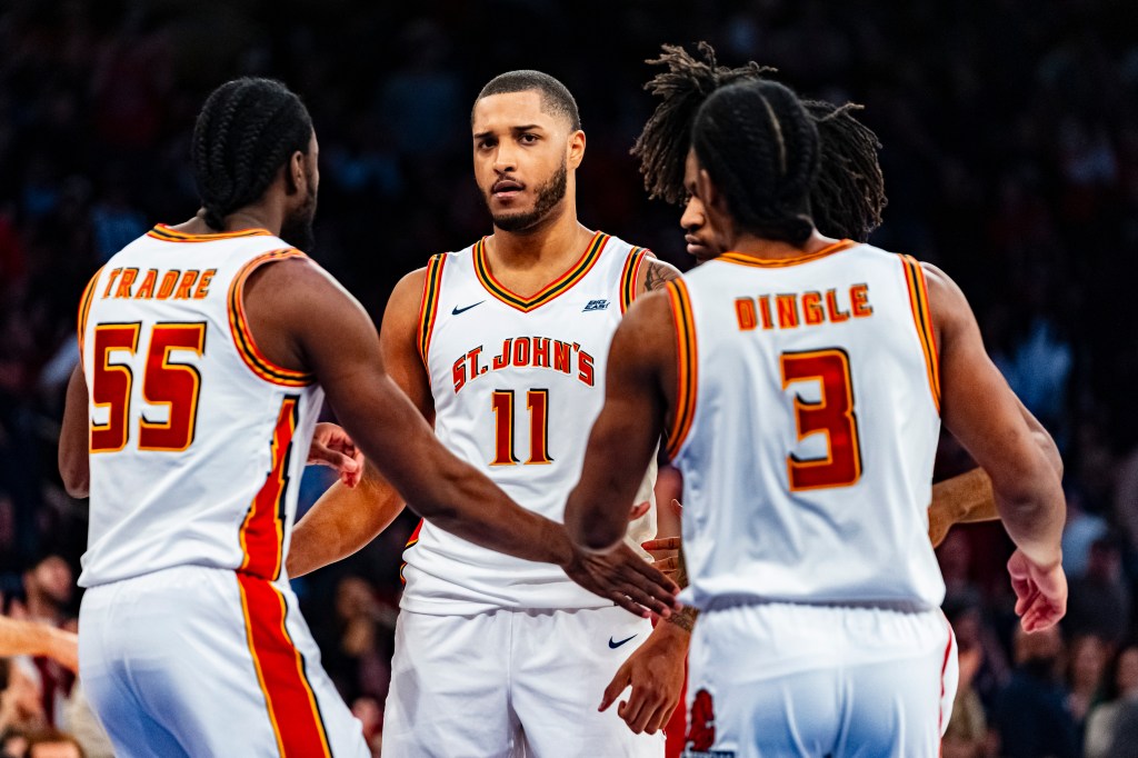 St. John's players huddle during a break in the second half of an NCAA college basketball game against UConn