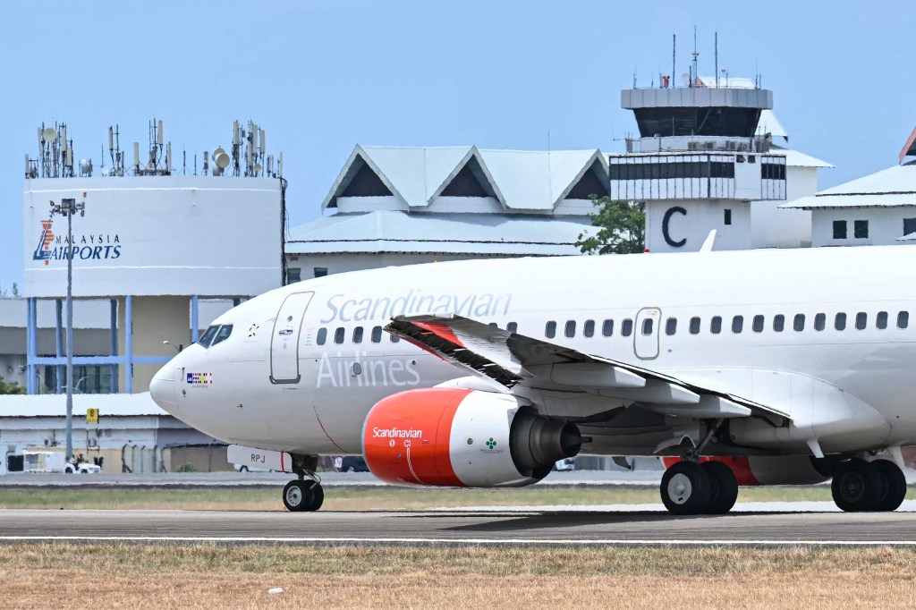 A Scandinavian Airlines aircraft carrying Norway's King Harald V prepares for take-off on the runway at Langkawi International Airport on the Malaysian resort island of Langkawi on March 3, 2024.