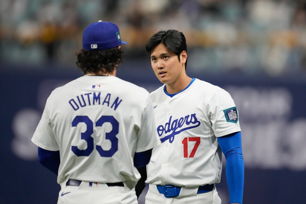 Los Angeles Dodgers' designated hitter Shohei Ohtani, right, talks with James Outman during warmups before an exhibition game between Team Korea and the Los Angeles Dodgers at the Gocheok Sky Dome in Seoul, South Korea, Monday, March 18, 2024.