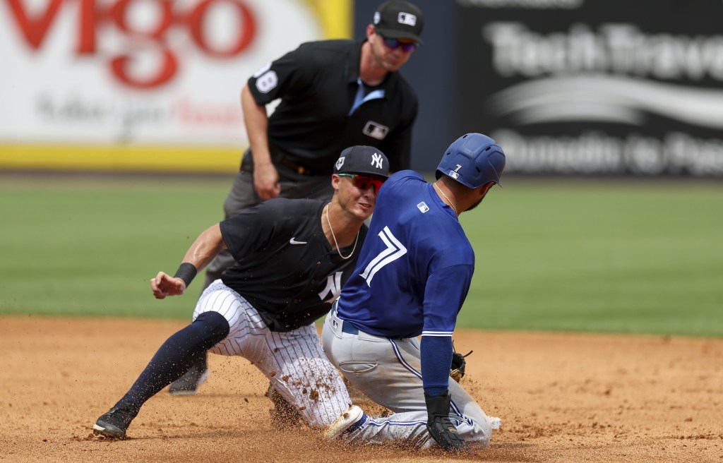 Isiah Kiner-Falefa is tagged out by Anthony Volpe after trying to steal second base in the Yankees' 10-9 exhibition win over the Blue Jays.