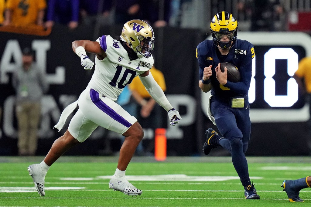 Michigan Wolverines quarterback J.J. McCarthy running with the football against Washington Huskies during the 2024 College Football Playoff national championship game.