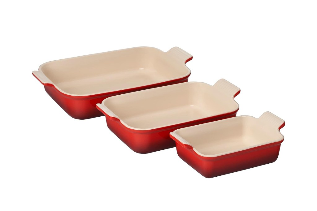 A group of red and white ceramic baking pans