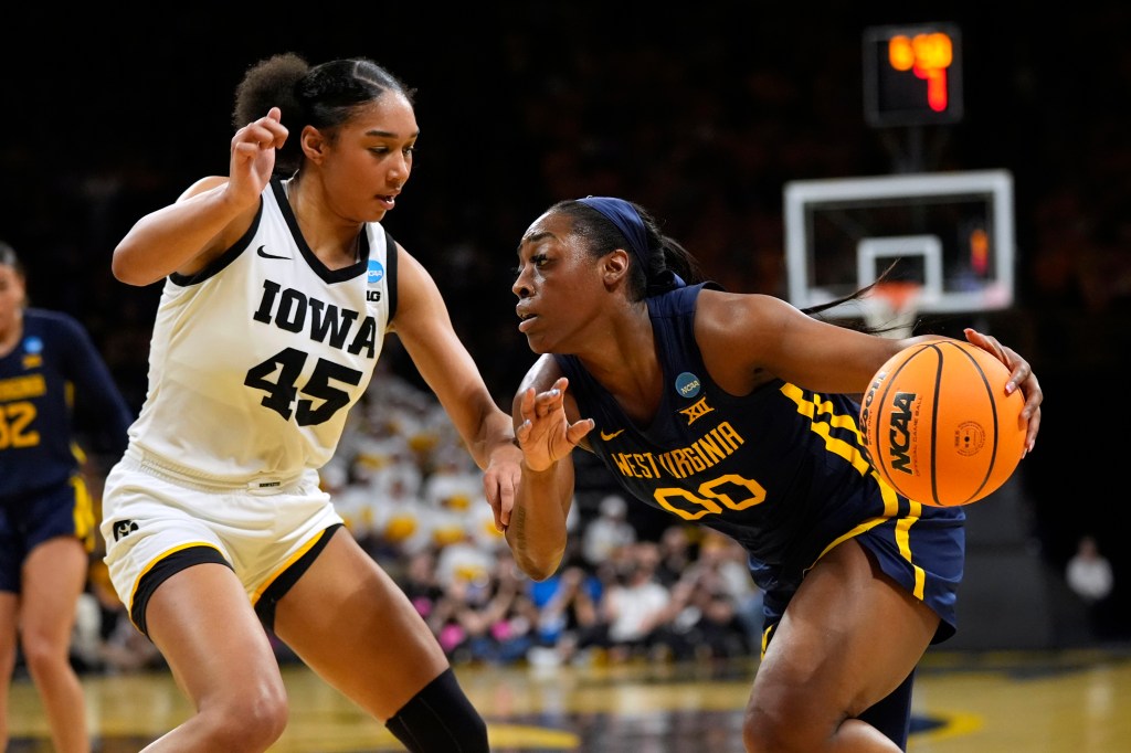 West Virginia guard Jayla Hemingway drives past Iowa forward Hannah Stuelke (45) in the first half on Monday night.