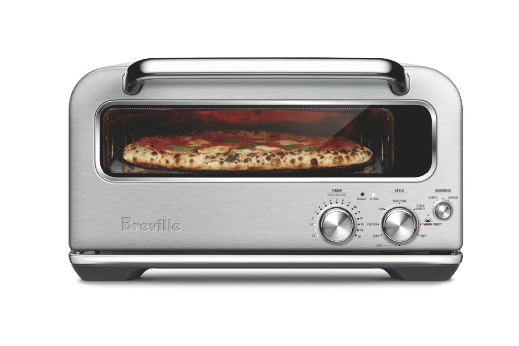 A silver toaster oven with a pizza in it