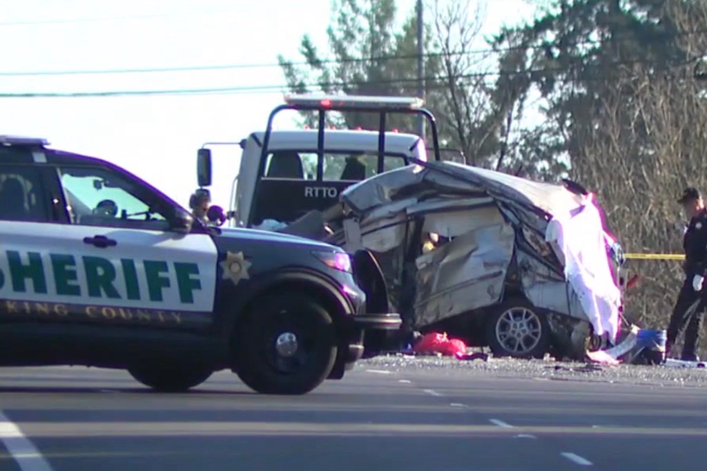 Mangled car behind sheriff vehicle. 