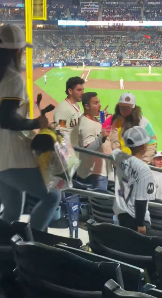 A Padres fan slaps a Giants fan across the face during a heated argument at Petco Park. 