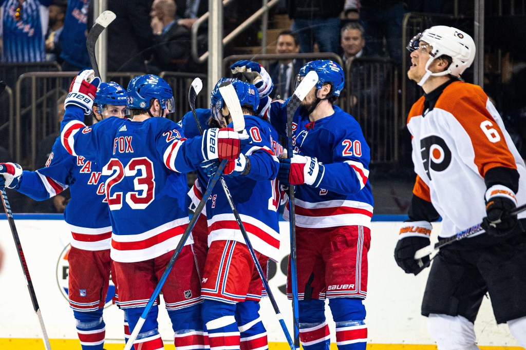 Rangers celebrate after Mika Zibanejad's goal in the second period of their 6-5 playoff-clinching OT win over the Flyers.