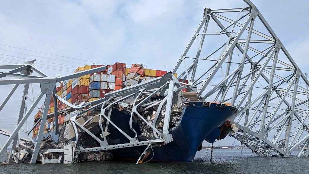 Part of a span of the collapsed Francis Scott Key Bridge is suspended on the container ship Dali in Baltimore, Maryland, U.S., March 26, 2024.