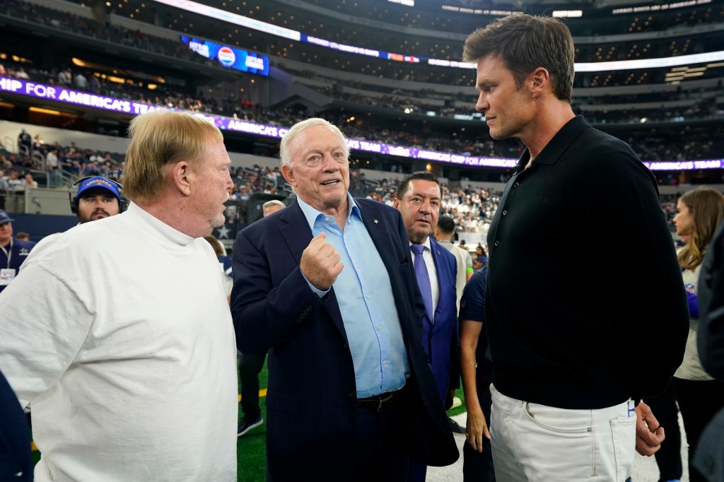 Las Vegas Raiders owner Mark Davis, left, Dallas Cowboys owner Jerry Jones, center, and former player Tom Brady, right, talk on the sideline during a game this season.