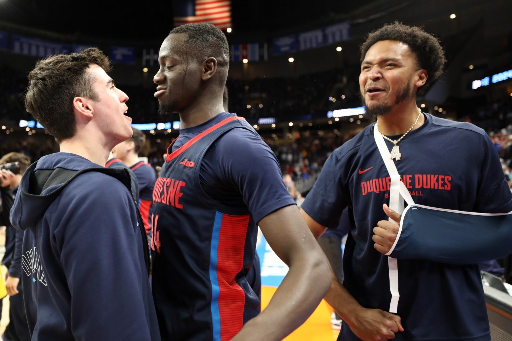 Fousseyni Drame #34 of the Duquesne Dukes reacts after defeating the Brigham Young Cougars during the second half in the first round of the NCAA Men's Basketball Tournament.