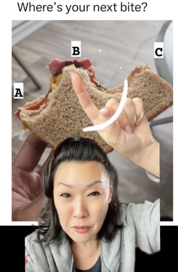 A woman holding up a sandwich during a debate.