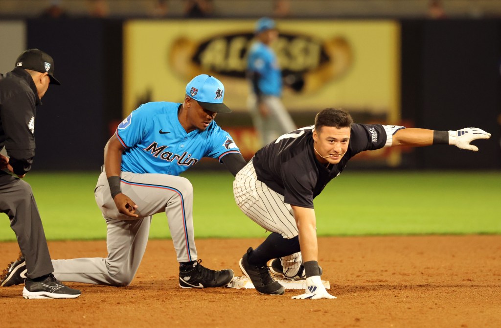 Yankees shortstop Anthony Volpe (11) is safe at second base during the fifth inning against the Miami Marlins  at George M. Steinbrenner Field.