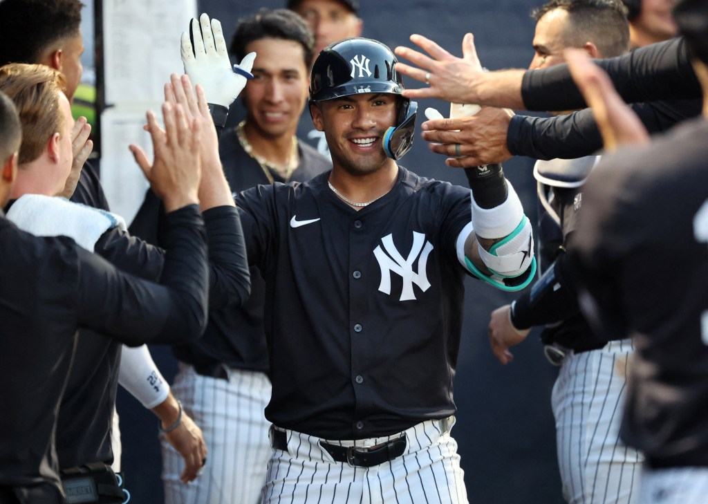 A smiling Gleyber Torres accepts congratulations from teammates after hitting a solo homer during the Yankees' 6-2 exhibition loss to the Pirates.