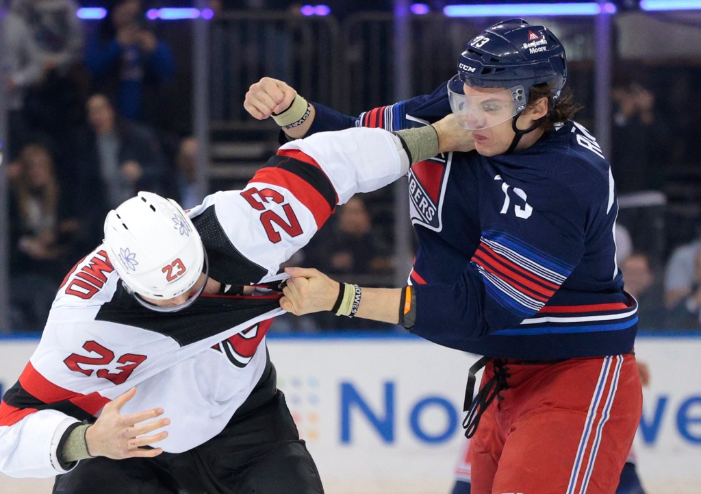 Matt Rempe (right) fights Kurtis MacDermid during a multi-player brawl that broke out in the opening seconds of the Rangers' win. 