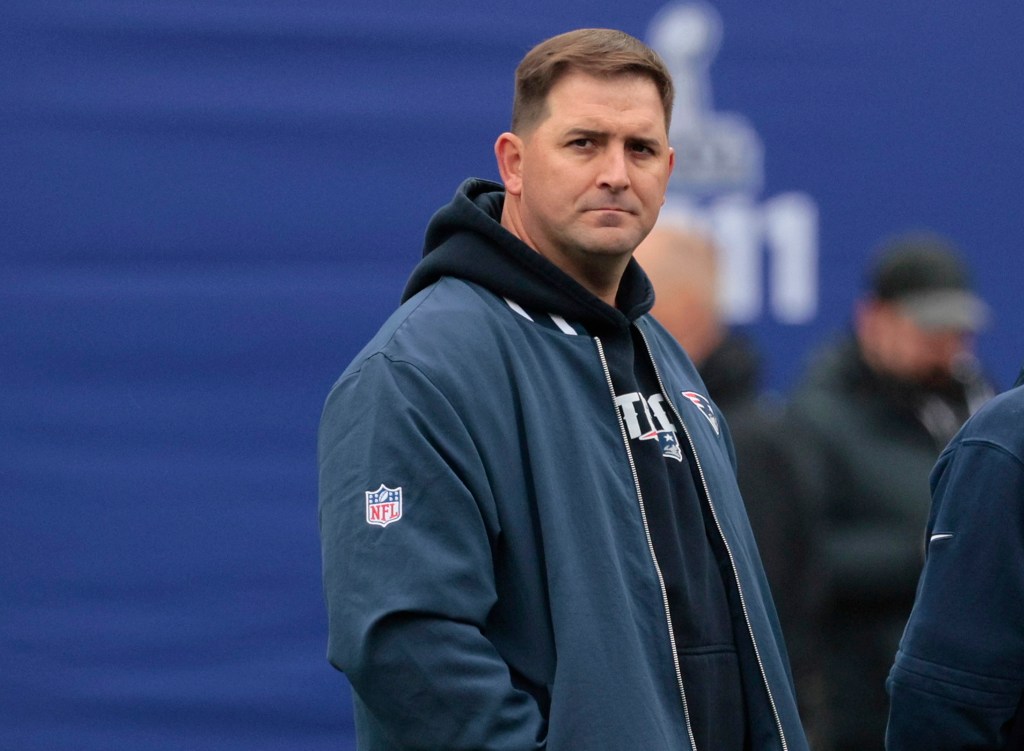 Former Giants head coach Joe Judge, now with the New England Patriots, conversing with Bill Belichick on the sideline of MetLife Stadium before a game.