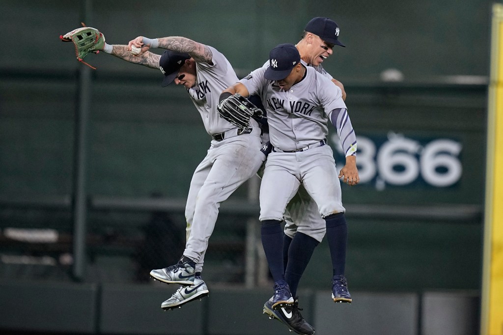 Yankees left fielder Alex Verdugo, left,center fielder Aaron Judge, right rear, and right fielder Juan Soto celebrate