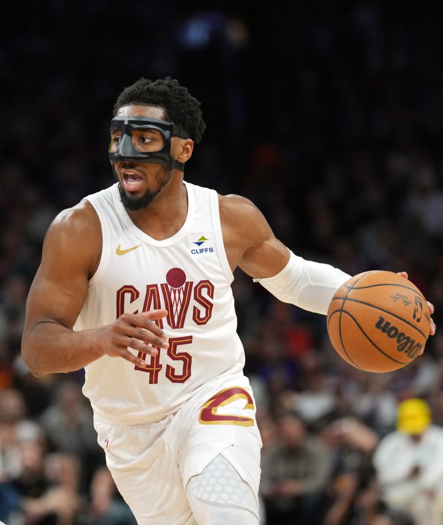 Cleveland Cavaliers guard Donovan Mitchell (45) dribbles against the Phoenix Suns during the first half at Footprint Center. 