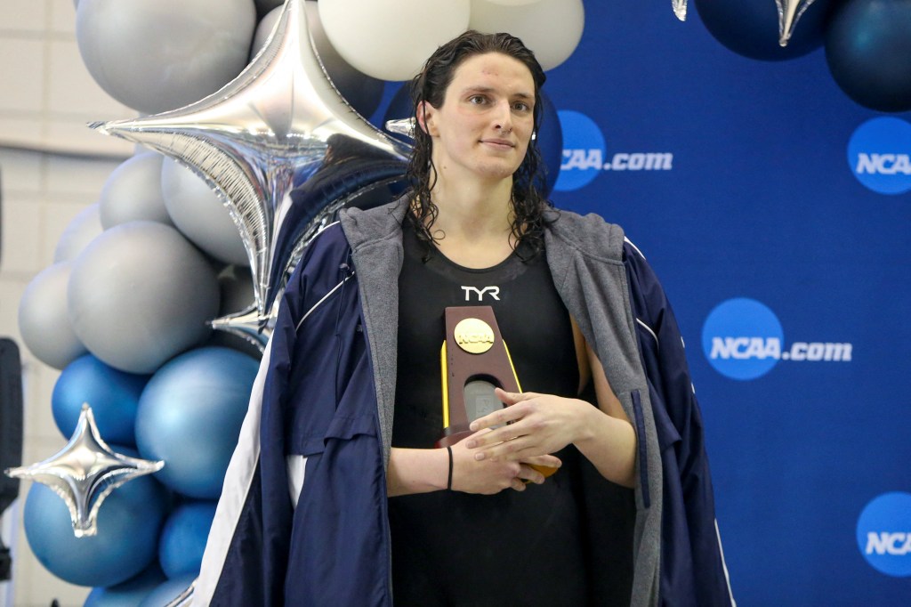 Penn Quakers swimmer Lia Thomas holding a trophy after winning at the NCAA Womens Swimming & Diving Championships