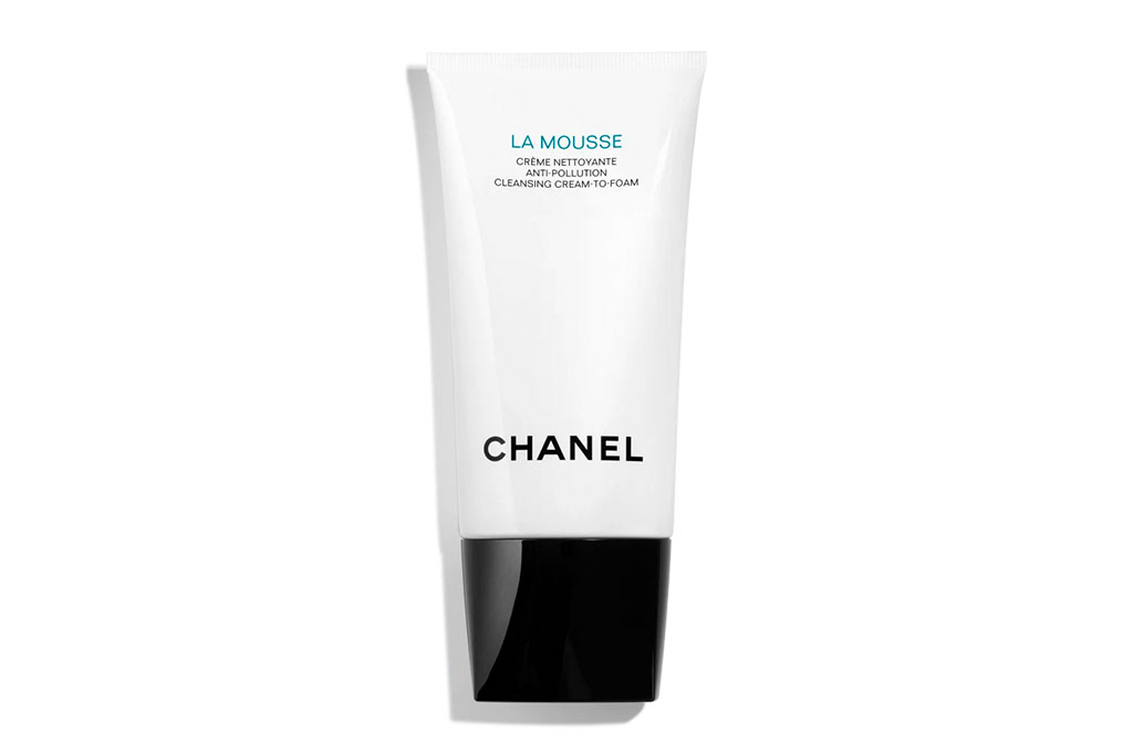 A white bottle with a black lid labeled 'cleanser'