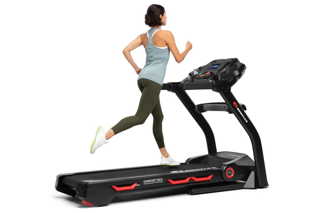 A woman running on a large treadmill