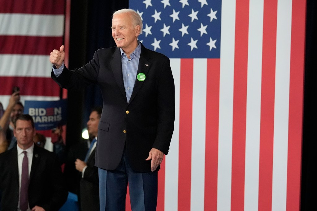 President Joe Biden in a suit, waving to supporters at a campaign event in Atlanta on March 9, 2024