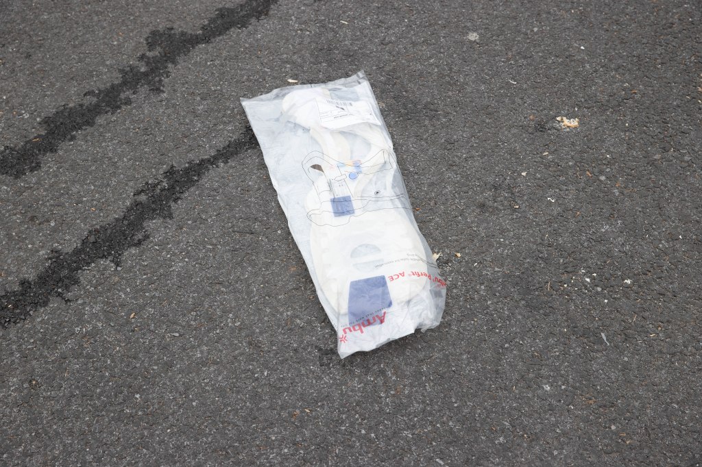 A medical neckbrace is seen on the ground at the scene where a woman died after she was run over by her own car at 2133 W 10th St. in Brooklyn, Wednesday, April 10, 2024.