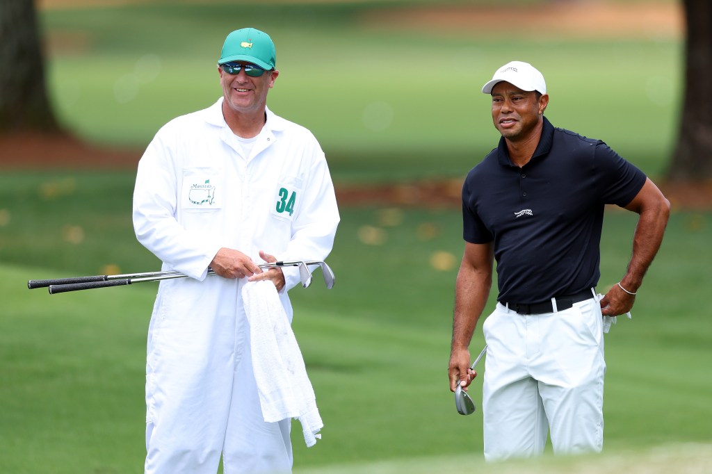 Tiger Woods and his caddie, Lance Bennett, standing on the practice green at Augusta National Golf Club during the 2024 Masters Tournament preview