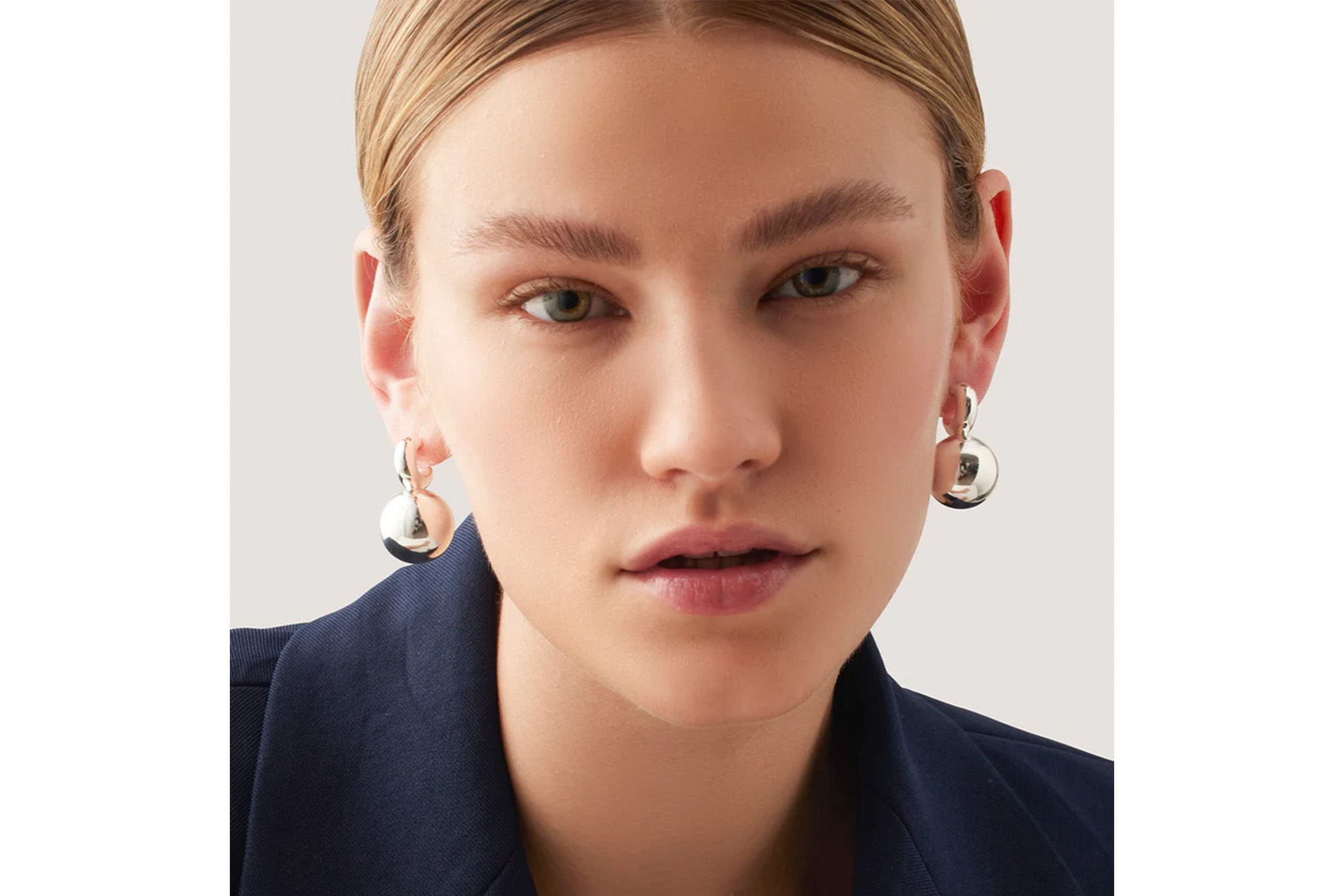 A model in silver earrings