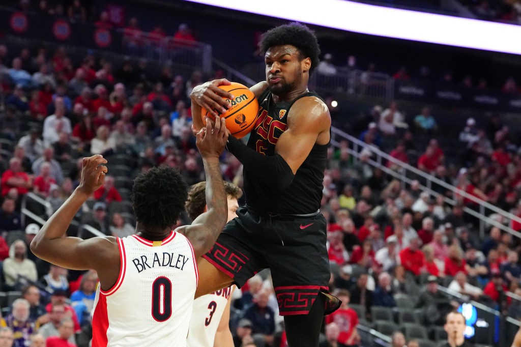 Southern California Trojans guard Bronny James (6) pulling down a defensive rebound from Arizona Wildcats guard Jaden Bradley (0) during a basketball game at the T-Mobile Arena in Las Vegas.