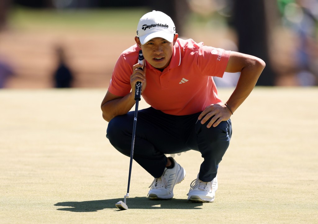 Collin Morikawa lines up a putt during the third round of the Masters.