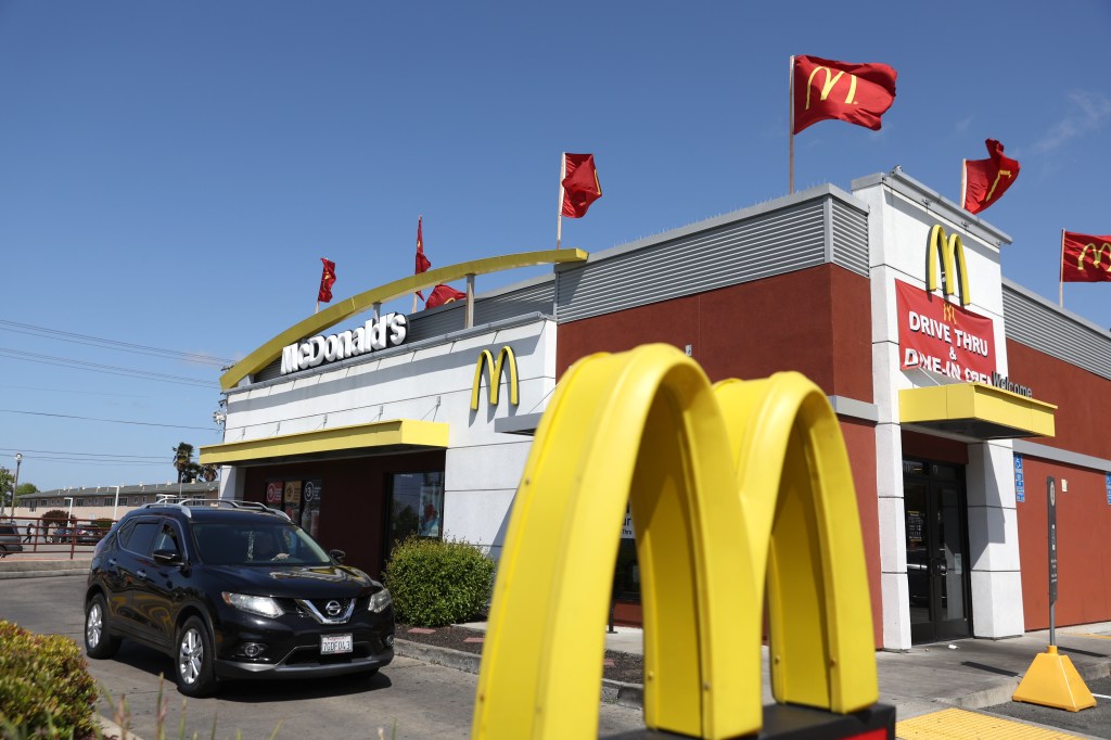 A sign is posted in front of a McDonald's restaurant